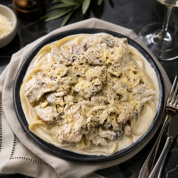 Bowl of black truffle chicken alfredo pasta from The Family Kitchen NZ