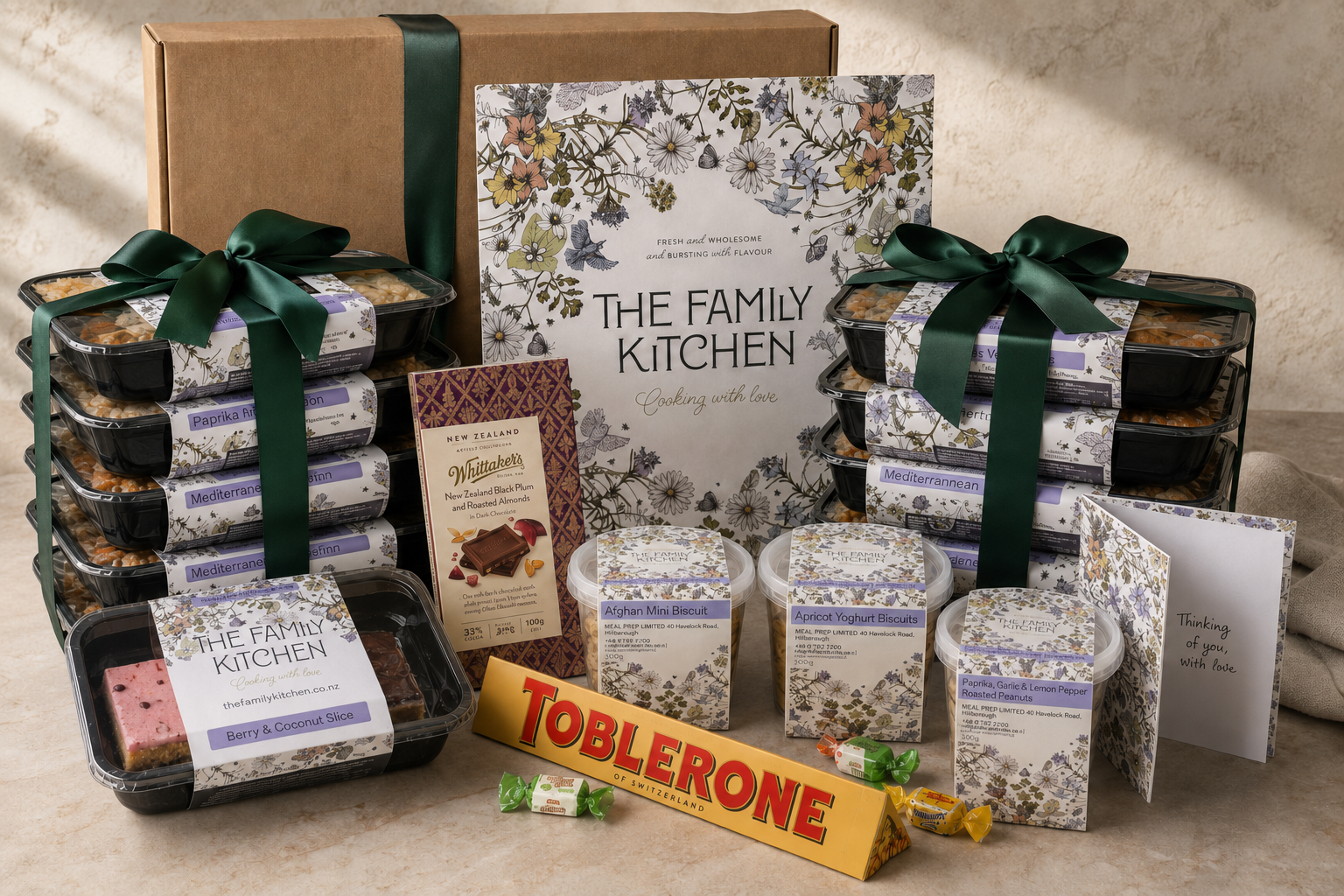 The Family Kitchen Full Comfort care package with ten chef-made meals, desserts, premium chocolates, snacks and a handwritten card.